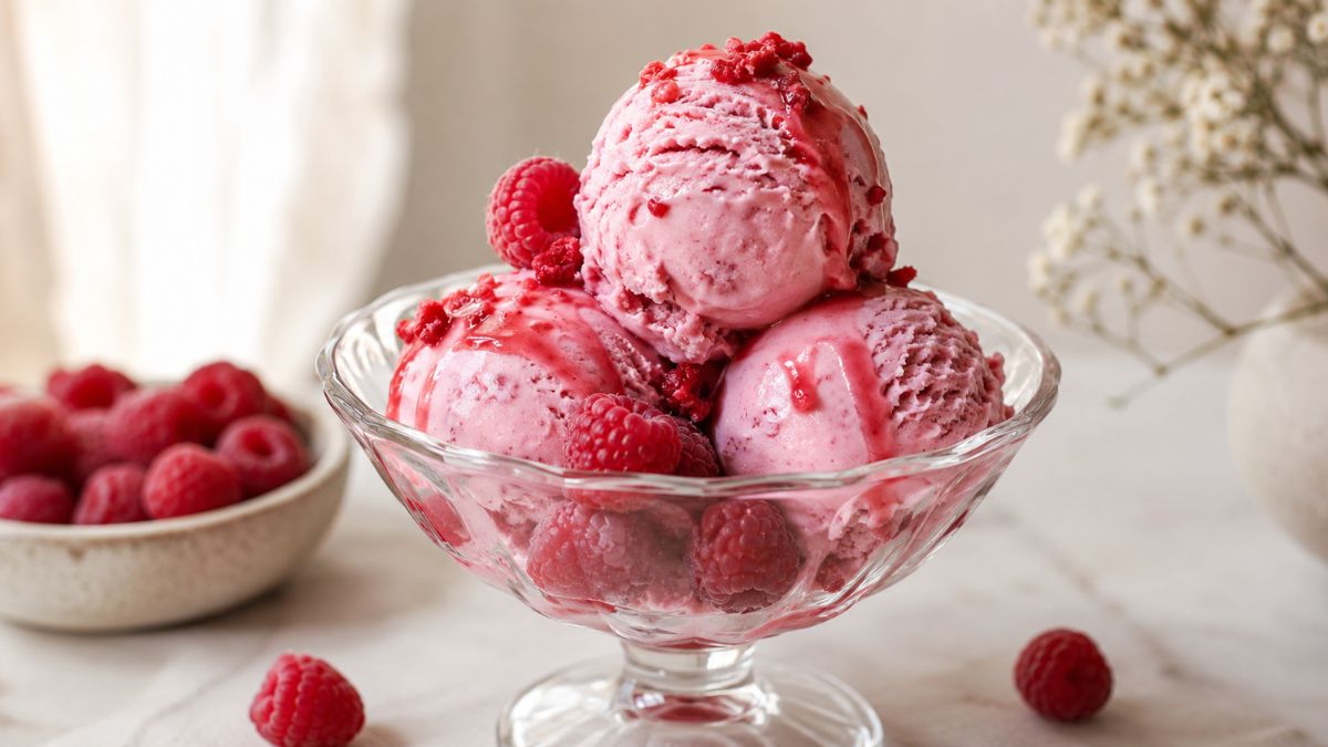 raspberry ice cream scoops with fresh raspberries