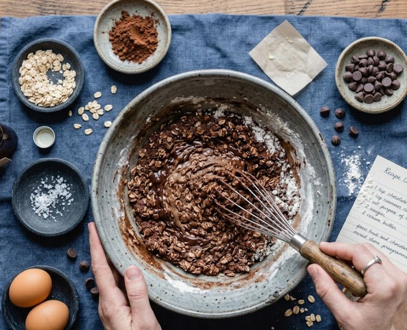 Preparing oats cocoa cookies dough with rolled oats and cocoa powder
