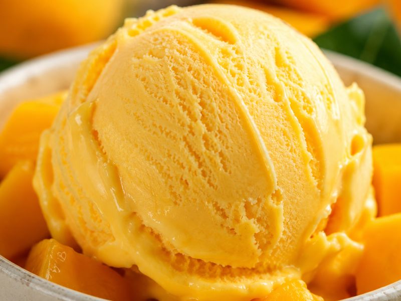 Homemade Propitious Mango Ice Cream stored in an airtight container