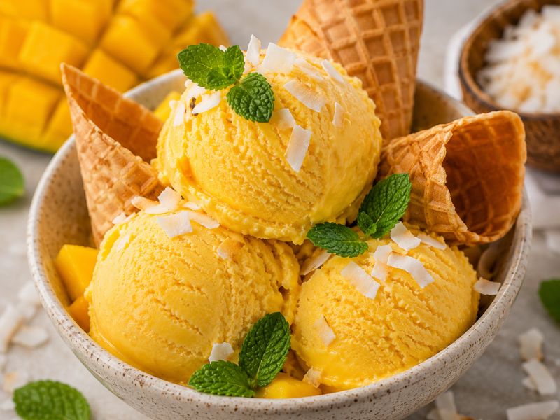 Creamy mango ice cream with fresh toppings