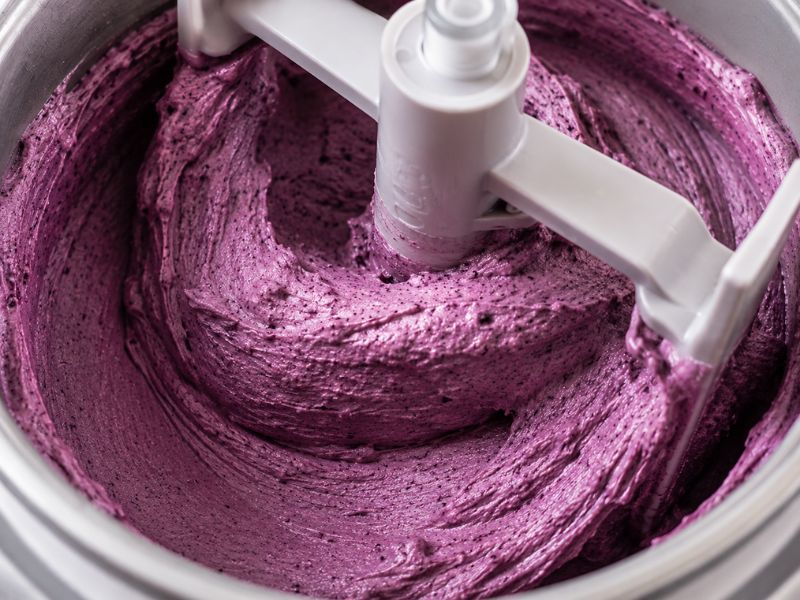 Ice cream maker churning smooth blackberry ice cream