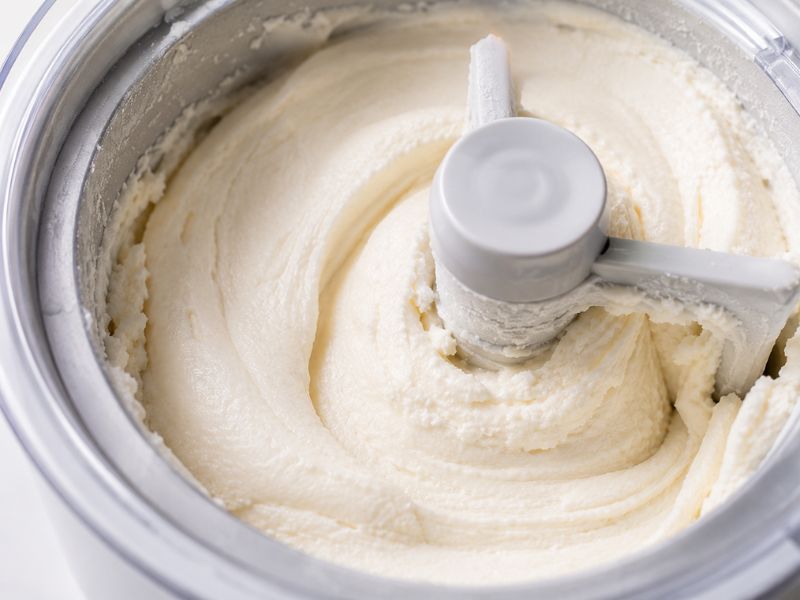 Creamy coconut ice cream being churned in an ice cream maker
