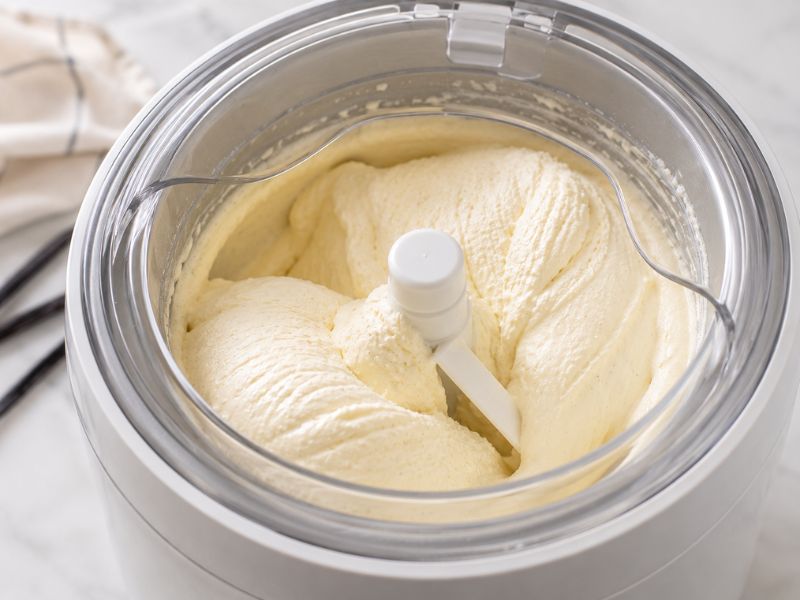 churning homemade vanilla ice cream in an ice cream maker