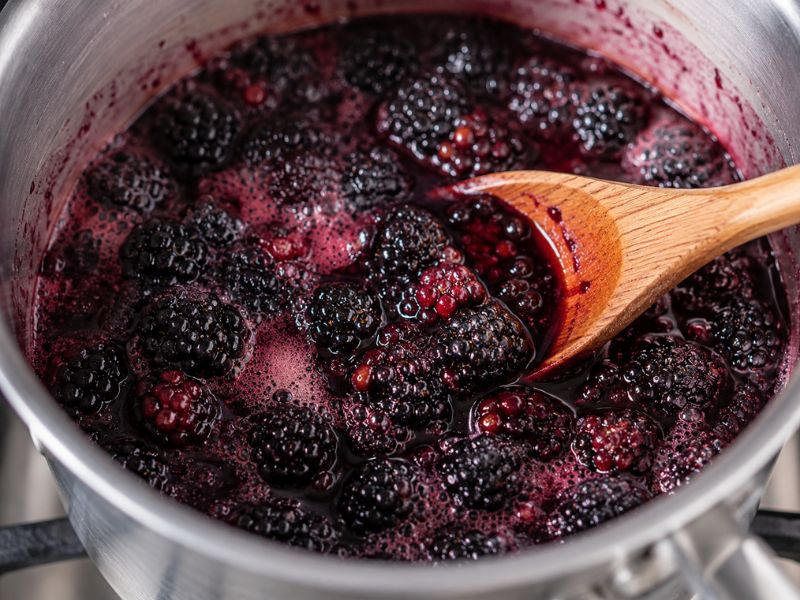 Fresh blackberries cooking with sugar and lemon juice for ice cream