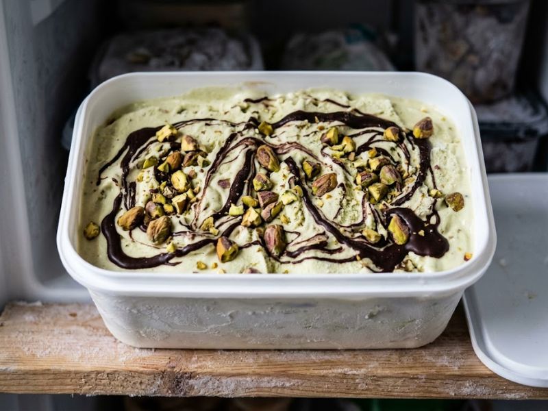 Frozen homemade pistachio ice cream with chocolate swirl