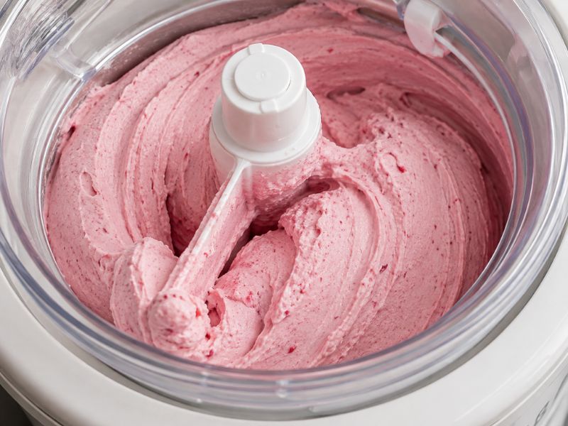 raspberry ice cream churning in an ice cream maker