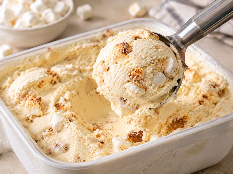 Scooping creamy homemade marshmallow ice cream