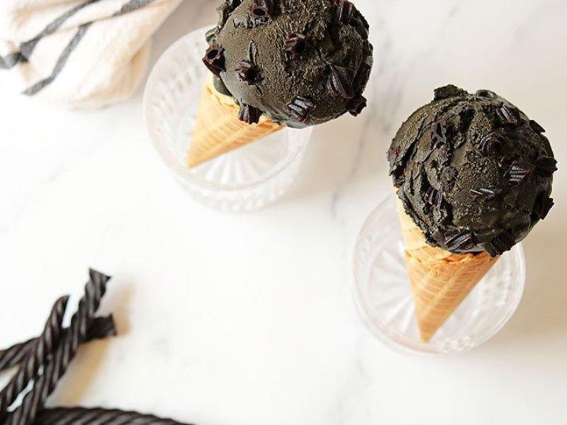 Black licorice ice cream served in a waffle cone with chocolate shavings