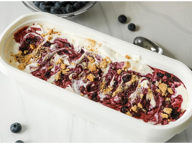 Blueberry compote and cheesecake ice cream base layered in a loaf pan