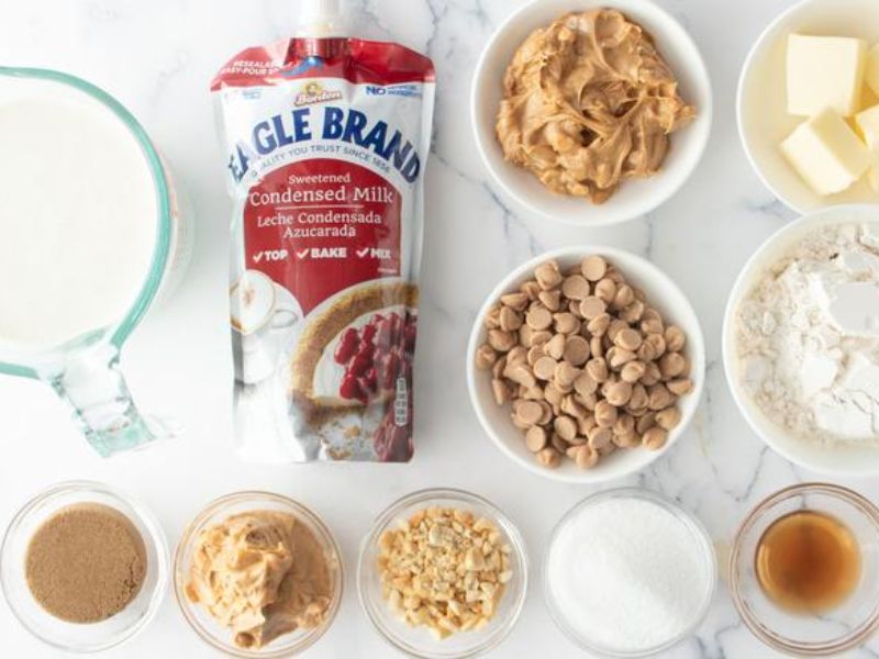 Ingredients for maple bacon crunch ice cream including cream, condensed milk, bacon, maple extract and toffee
