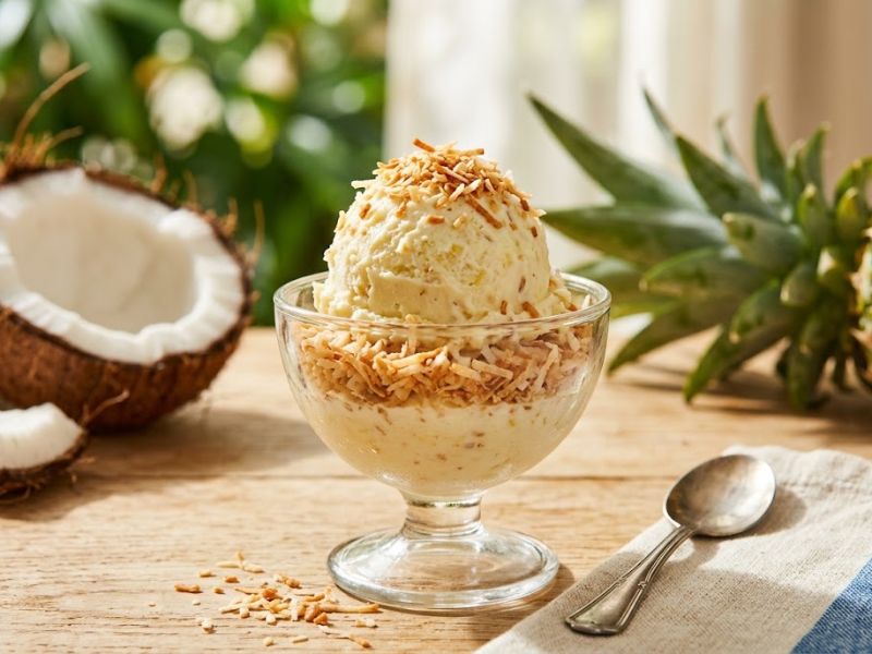 Pineapple coconut ice cream topped with toasted shredded coconut